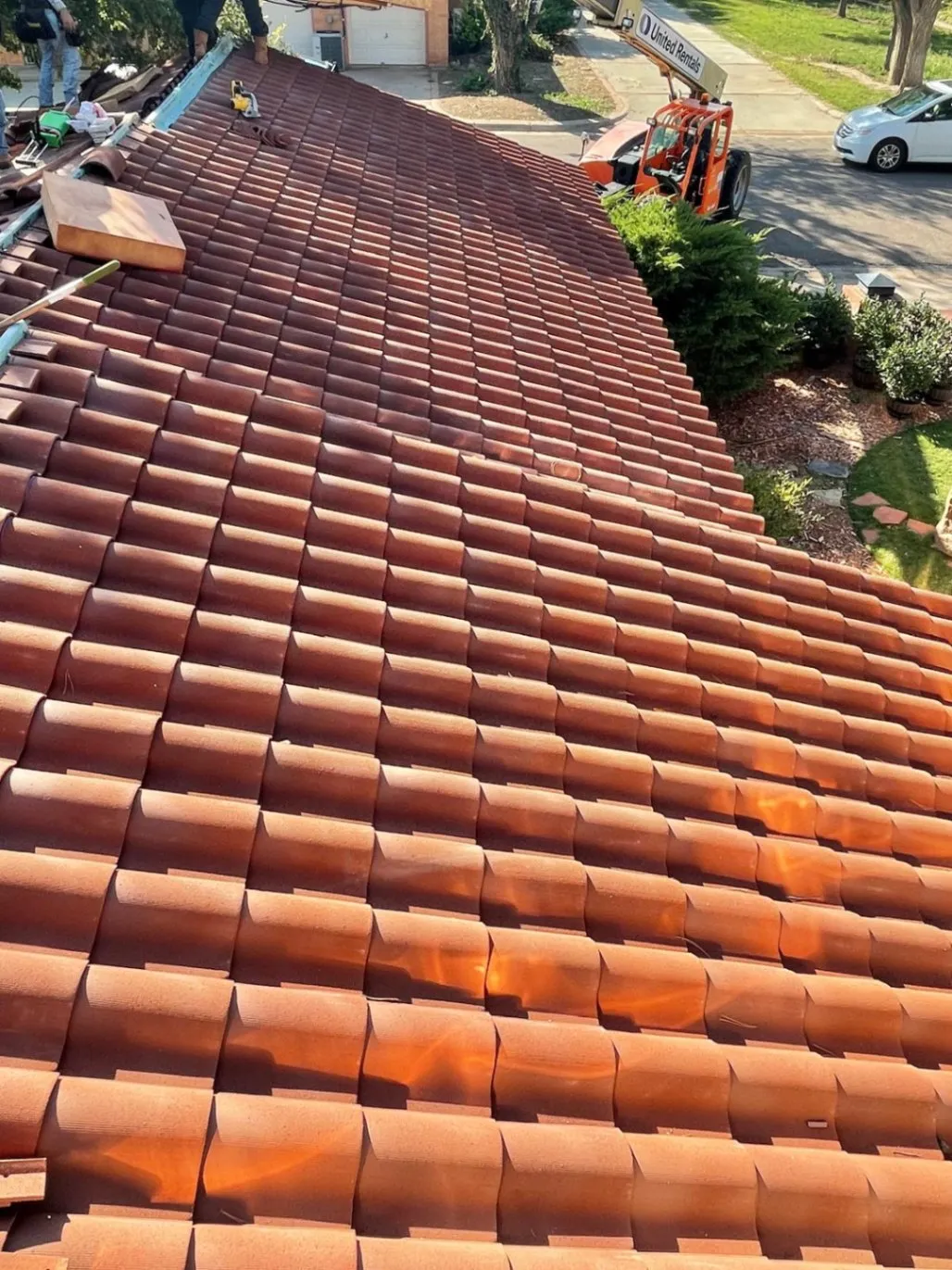Close-up of red clay tile roof installation in progress